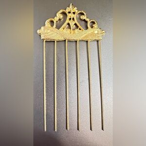 vintage hair pick from 1950s is a beautiful scrolled design in gold tone metal.
